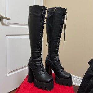 Black knee-high heeled boots